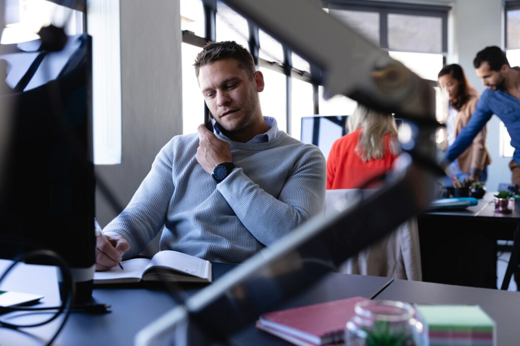 Caucasian man working in office and having a phone call