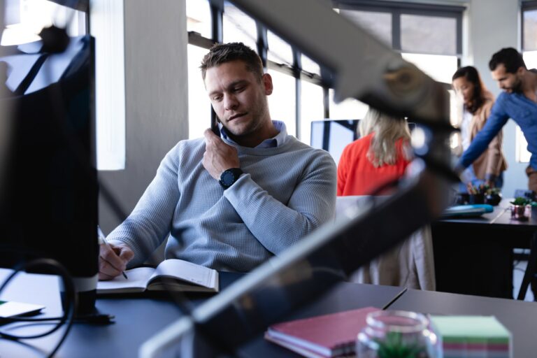 Caucasian man working in office and having a phone call