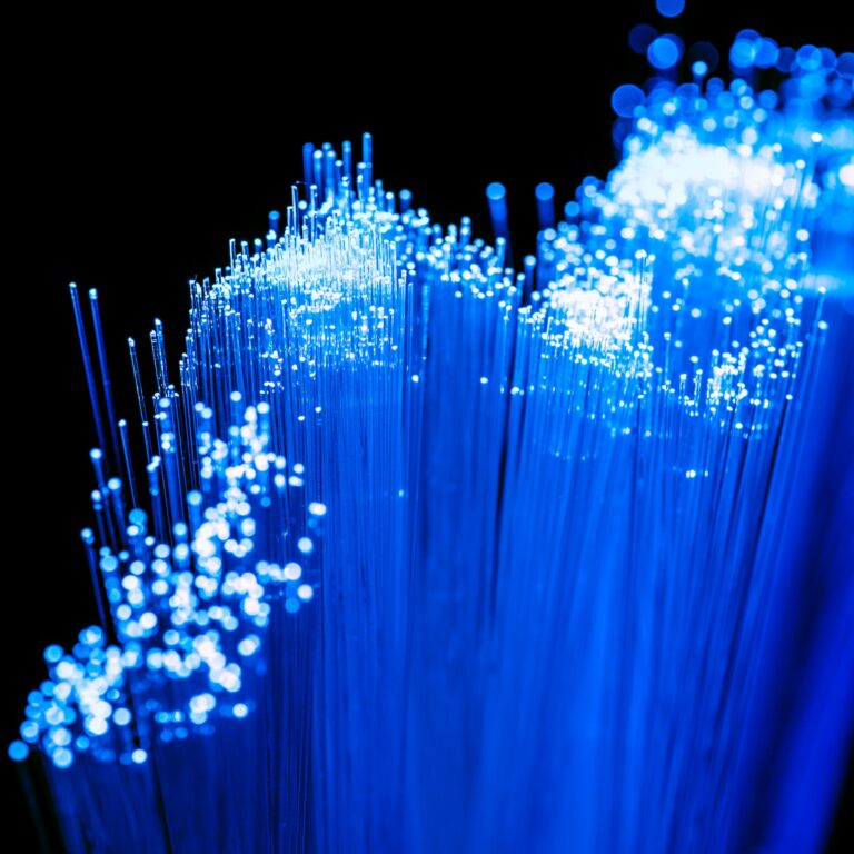 Close up of shiny blue fiber optics texture, communication technology