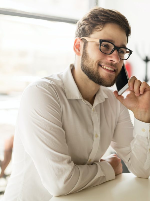 businessman-holding-mobile-device-in-cafe.jpg