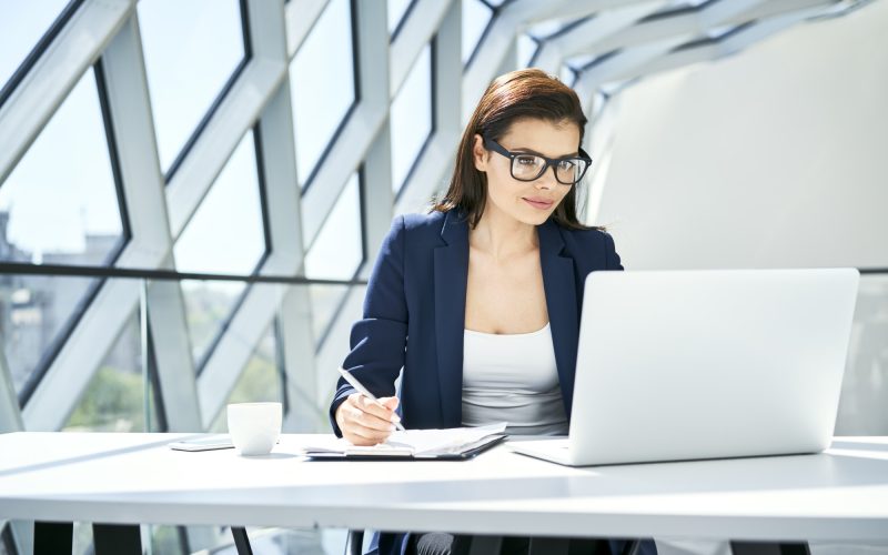 Businesswoman working at desk in modern office