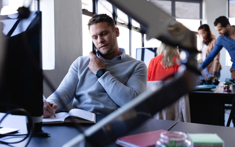 Caucasian man working in office and having a phone call