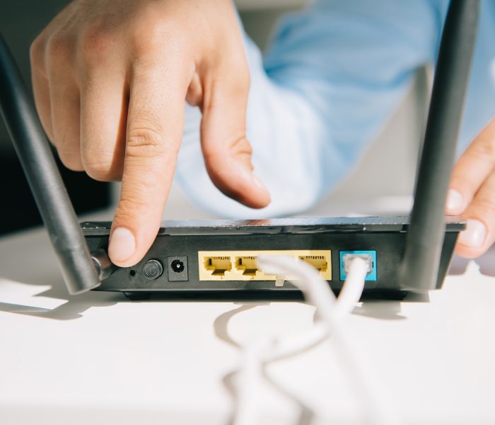 cropped view of businessman switching on router
